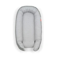 Cozy Nest in grey by Done By Deer, a soft and luxurious baby nest providing a safe space for play and tummy time.