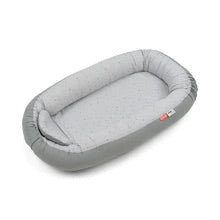 Cozy Nest by Done By Deer in grey, a soft cotton baby nest for safe play and tummy time.